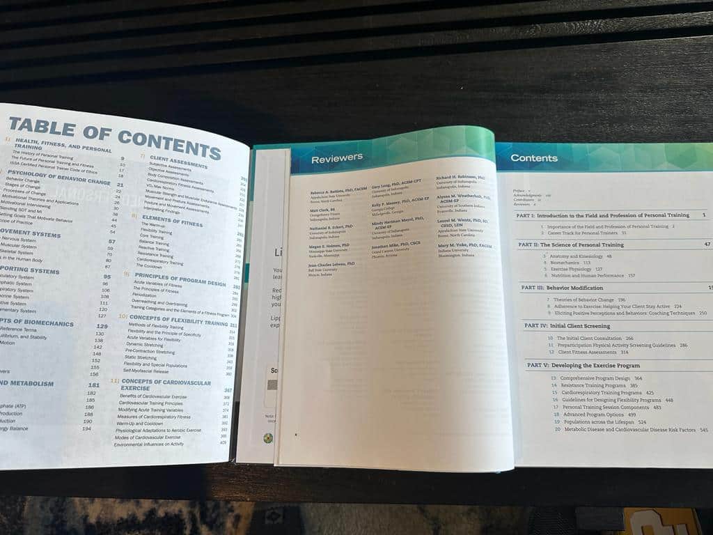 ISSA and ACSM textbooks open to table of contents  - course layouts 