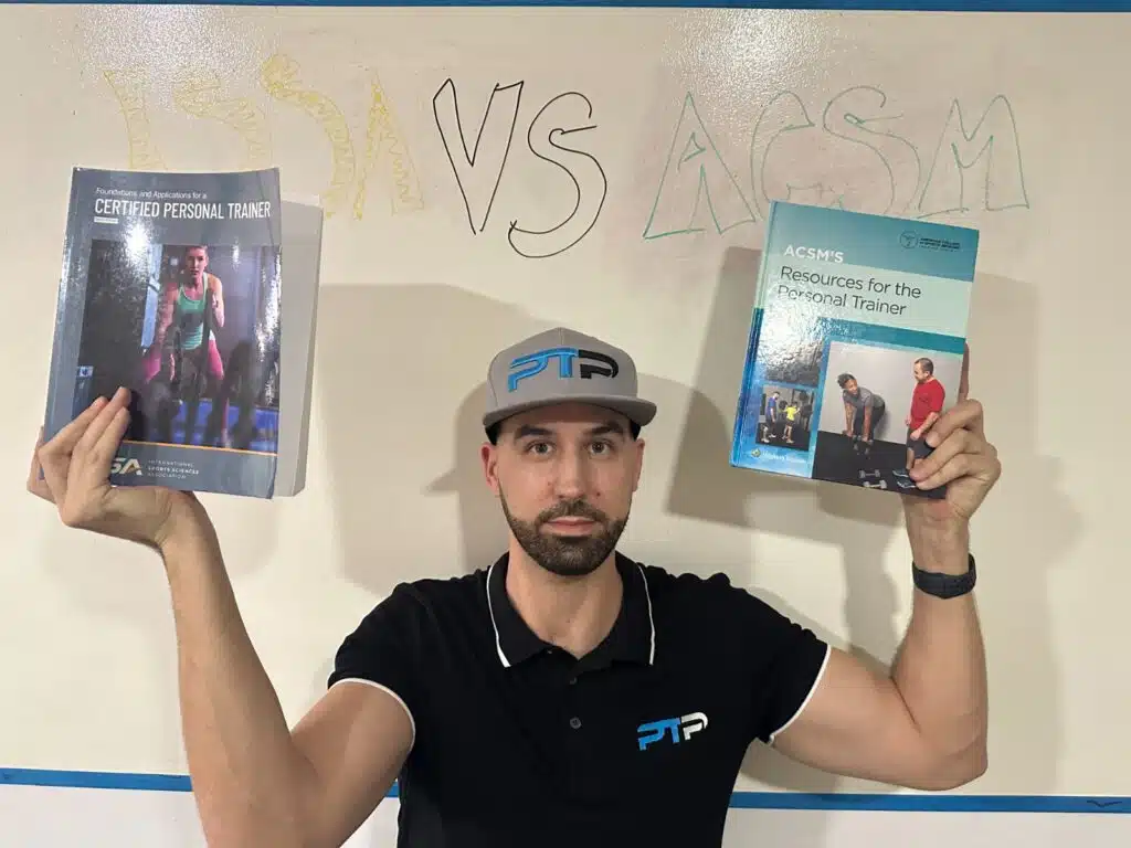 ISSA vs ACSM - Which Fitness Certification is Best? 41 Tyler Read holds up ACSM and ISSA textbooks against a whiteboard saying ISSA vs ACSM