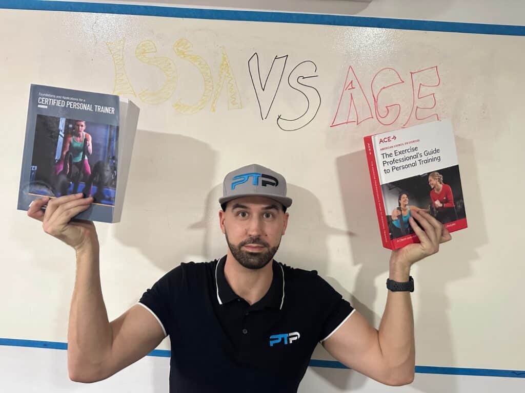 Tyler Read holds up both ISSA and ACE textbooks against a whiteboard that reads issa vs ace