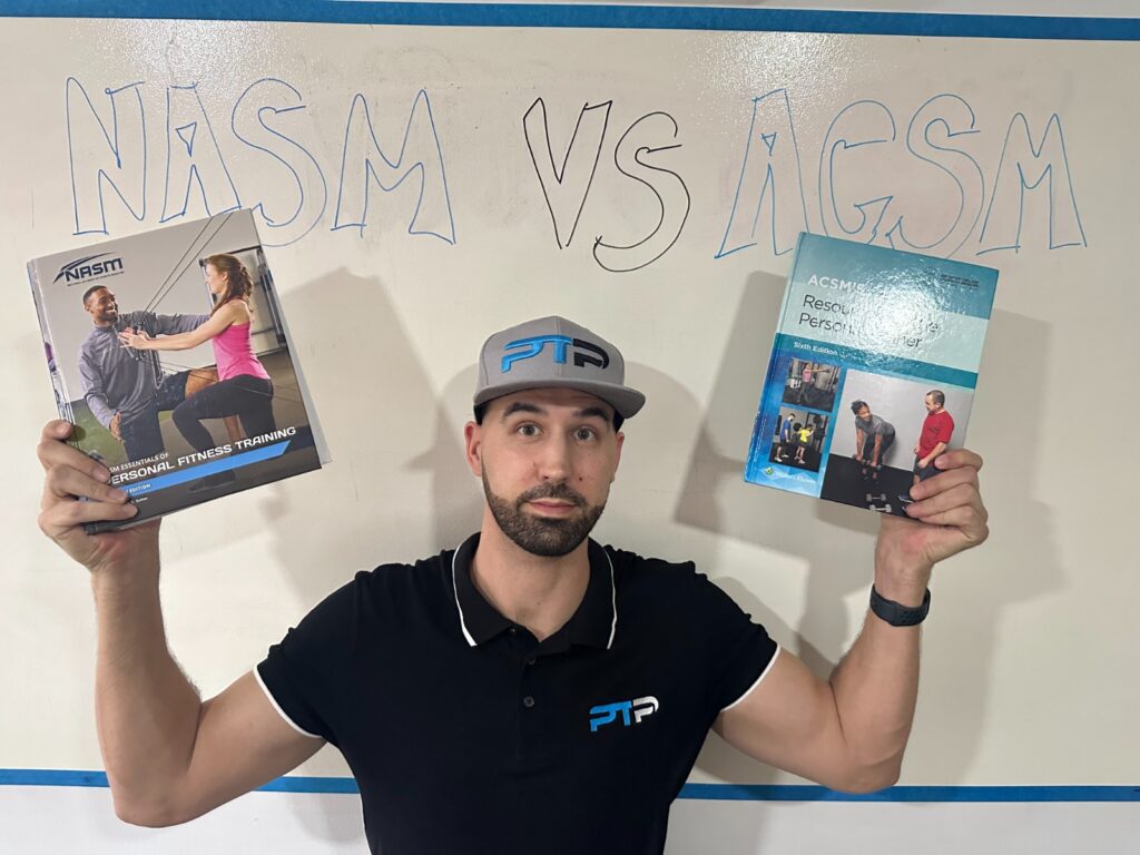 NASM vs ACSM - Tyler Read holds up NASM and ACSM textbooks in front of whiteboard with lettering 