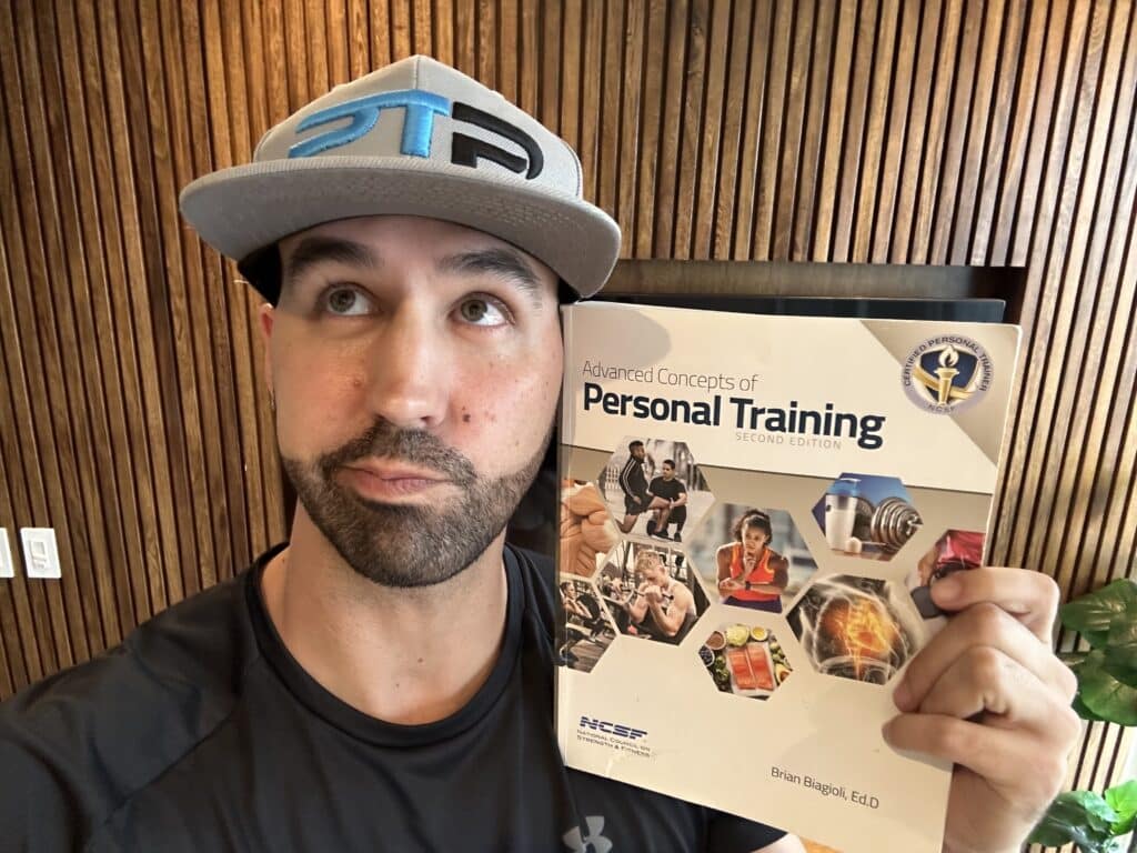 is the ncsf cpt certification worth it. Tyler holds up NCSF Personal Training Textbook and decides if the NCSF CPT makes sense for his personal training career