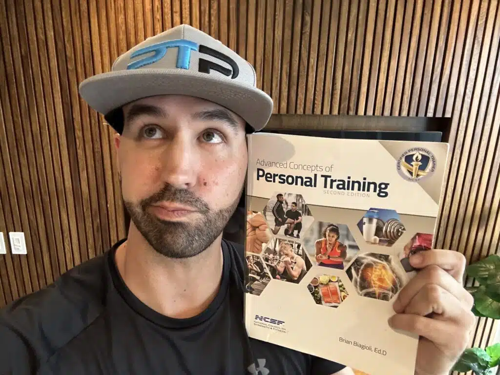 is the ncsf cpt certification worth it. Tyler holds up NCSF Personal Training Textbook and decides if the NCSF CPT makes sense for his personal training career