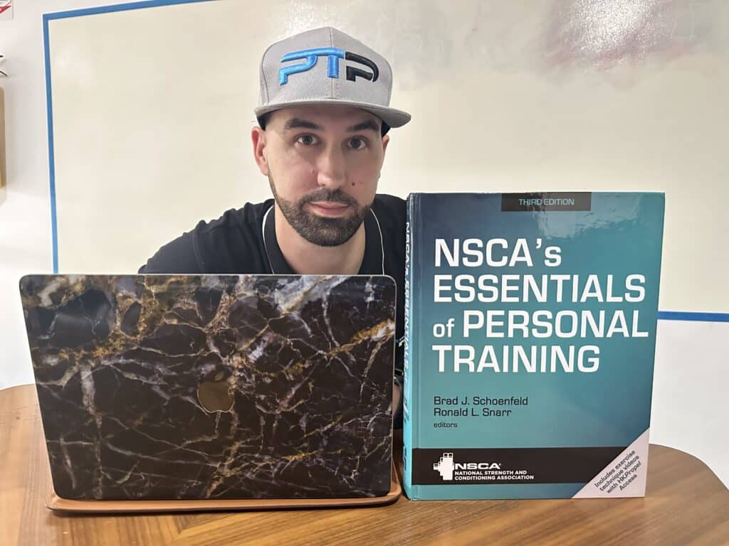 NSCA cpt review - Tyler Read holds the NSCA textbook to review the NSCA personal training certification