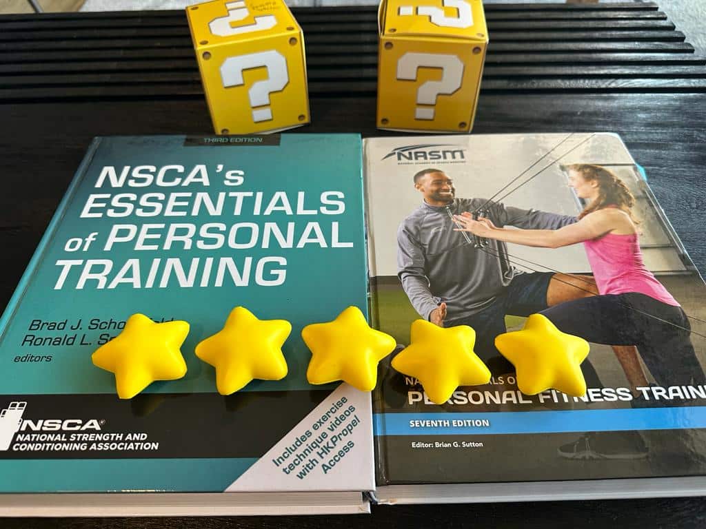 NSCA vs NASM - NASM and NSCA textbooks on table with yellow starts and yellow question boxes behind them