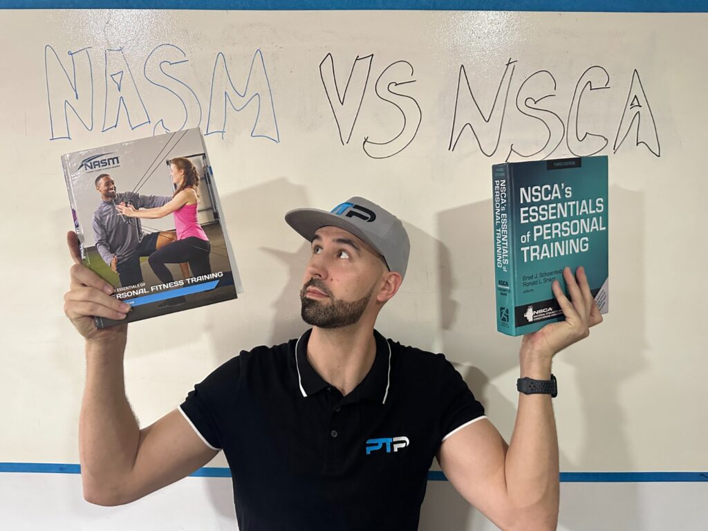 NASM vs NSCA - Tyler read holds up textbooks for NSM and NSCA in front of whiteboard 