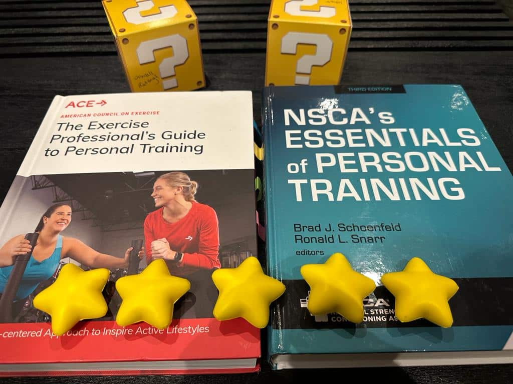 NSCA vs ACE - textbooks for ACE and NSCA on table with gold stars and yellow question boxes - which is the best