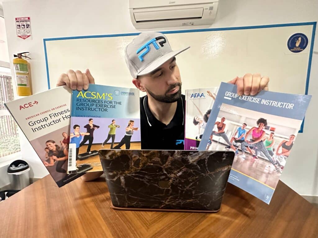 Best group fitness certifications. Tyler Read holds up the textbooks of the best group fitness instructor certifications - which group exercise certification is the best?