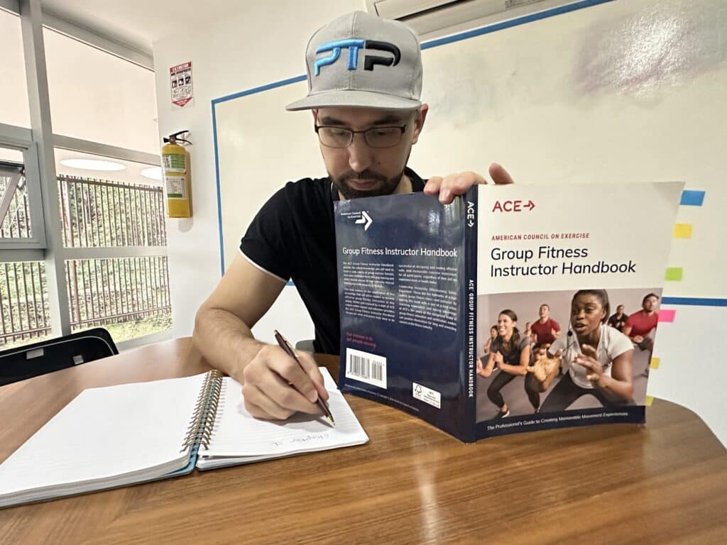 ace group fitness instructor review - Tyler read holds up ace gfi handbook while taking test - how hard is the ace exam