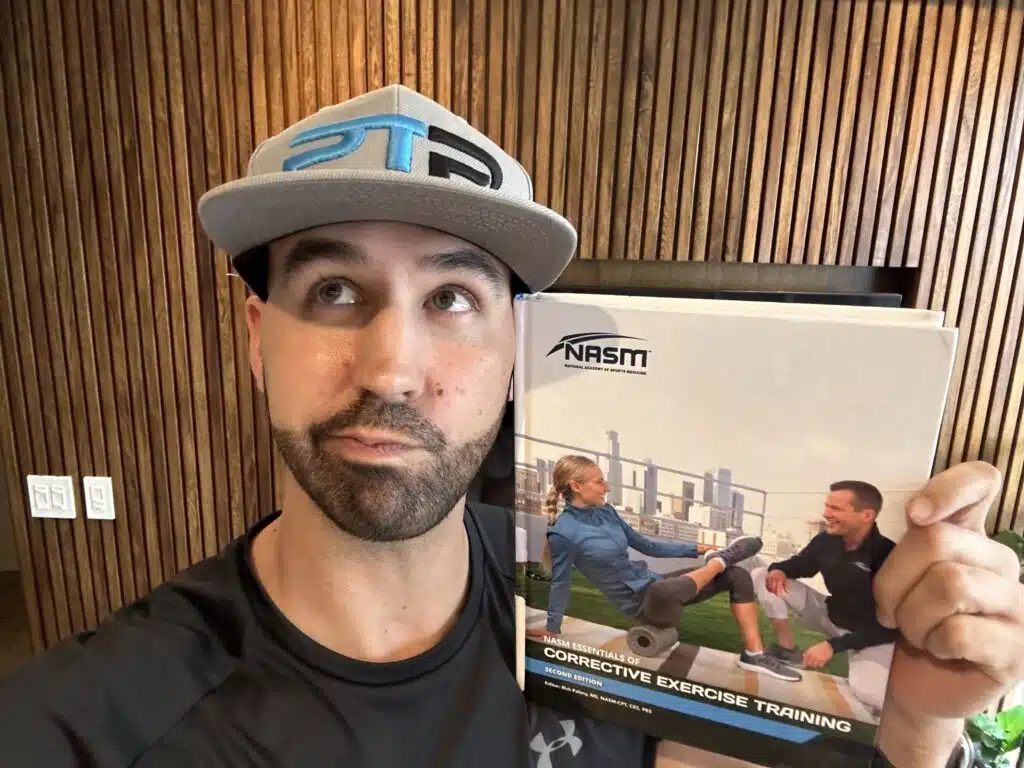 is the nasm ces certification worth it. Tyler holds up NASM Corrective Exercise Specialist Textbook and decides if the NASM CES makes sense for his personal training career