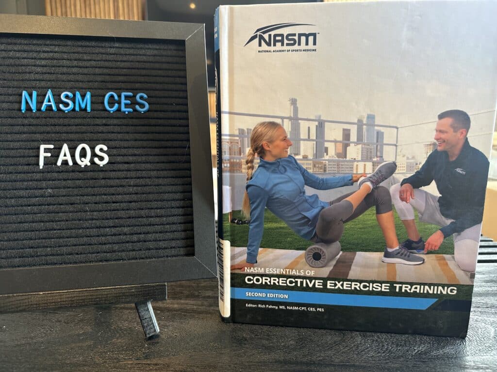 nasm ces FAQs - nasm ces textbook on table with frequently asked questions regarding nasm corrective exercise  specialist 