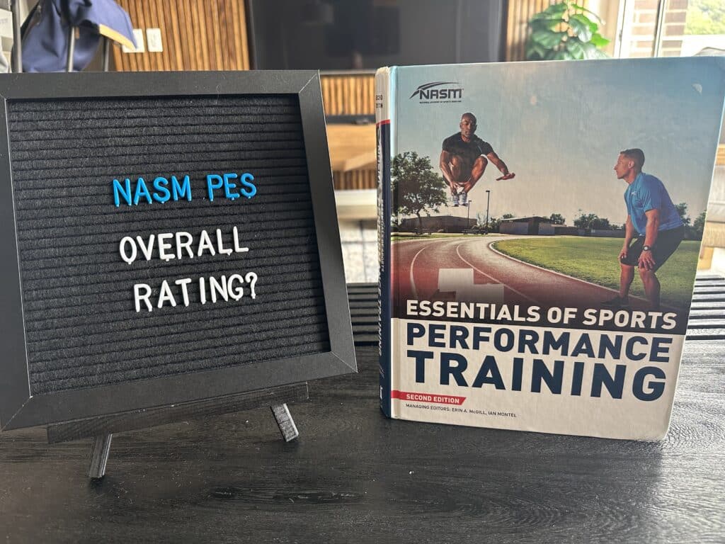 nasm pes overall rating - NASM performance enhancement specialist textbook displayed on table with lettering board