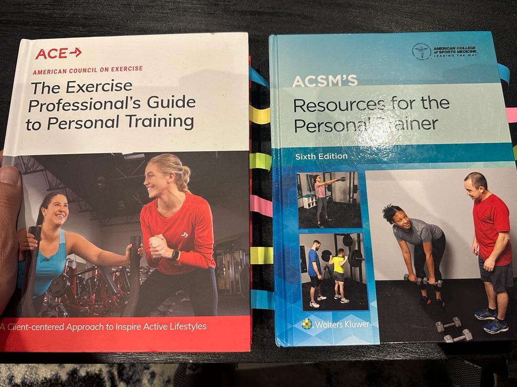 ACE and ACSM final exams. The ACE and ACSM textbooks on table in preparation to take each personal trainer certification exam