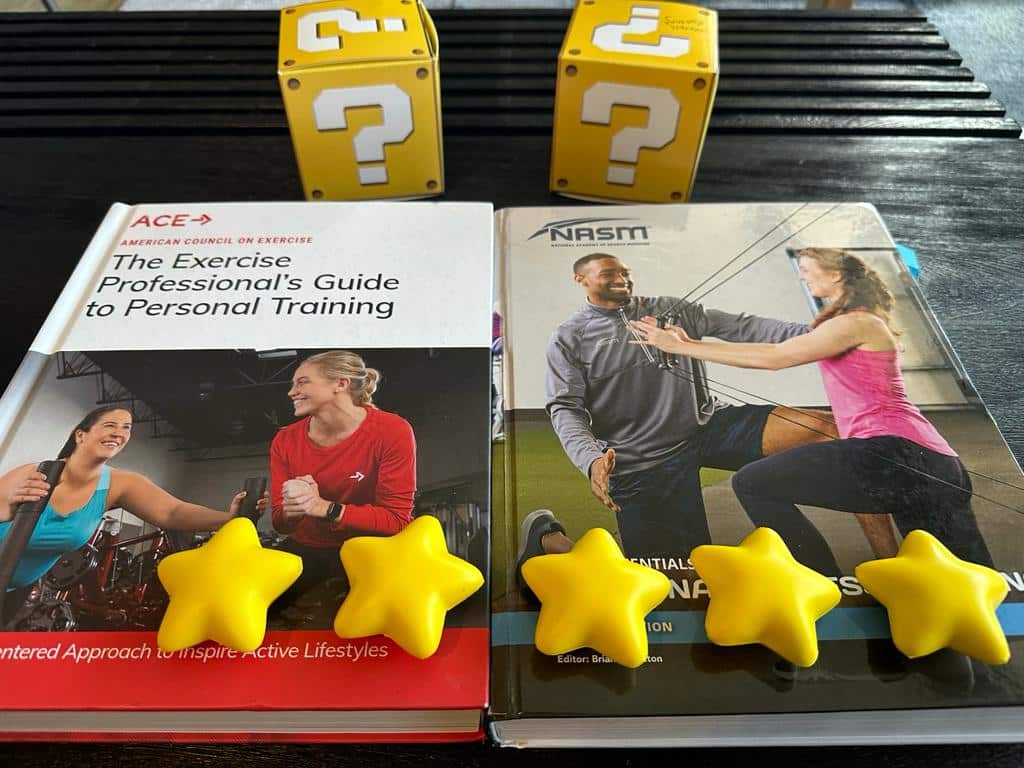 NASM vs ACE overall rating - ACE and NASM textbooks with yellow stars on them and question mark boxes - which is best for you