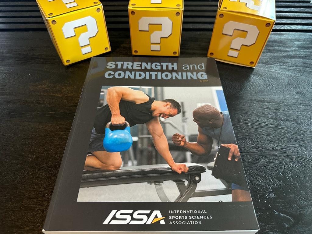 ISSA strength and Conditioning textbook laid out on table with yellow question boxes - top strength certifications