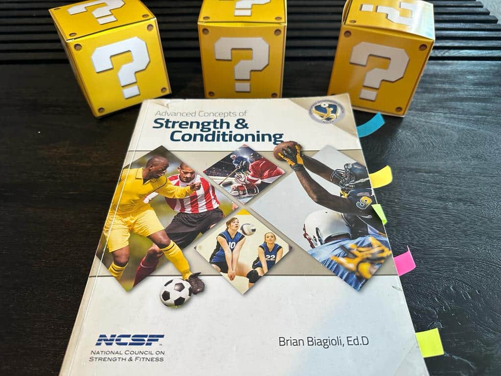 5 best strength and conditioning certifications - the NCSF advanced concepts of strength and conditioning textbook with yellow question mark boxes and sticky notes