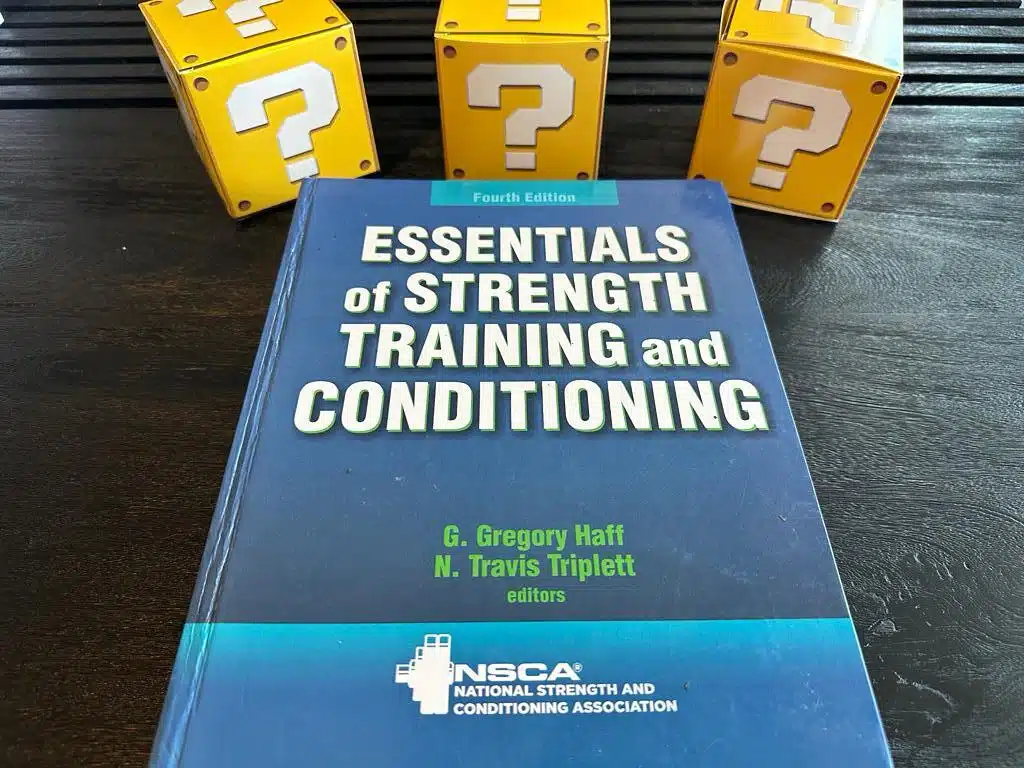 5 Best Strength and Conditioning Certifications (CSCS, PES, SCCC) 8 strength and conditioning coach certifications - NSCA CSCS textbook laid out on table with yellow question boxes