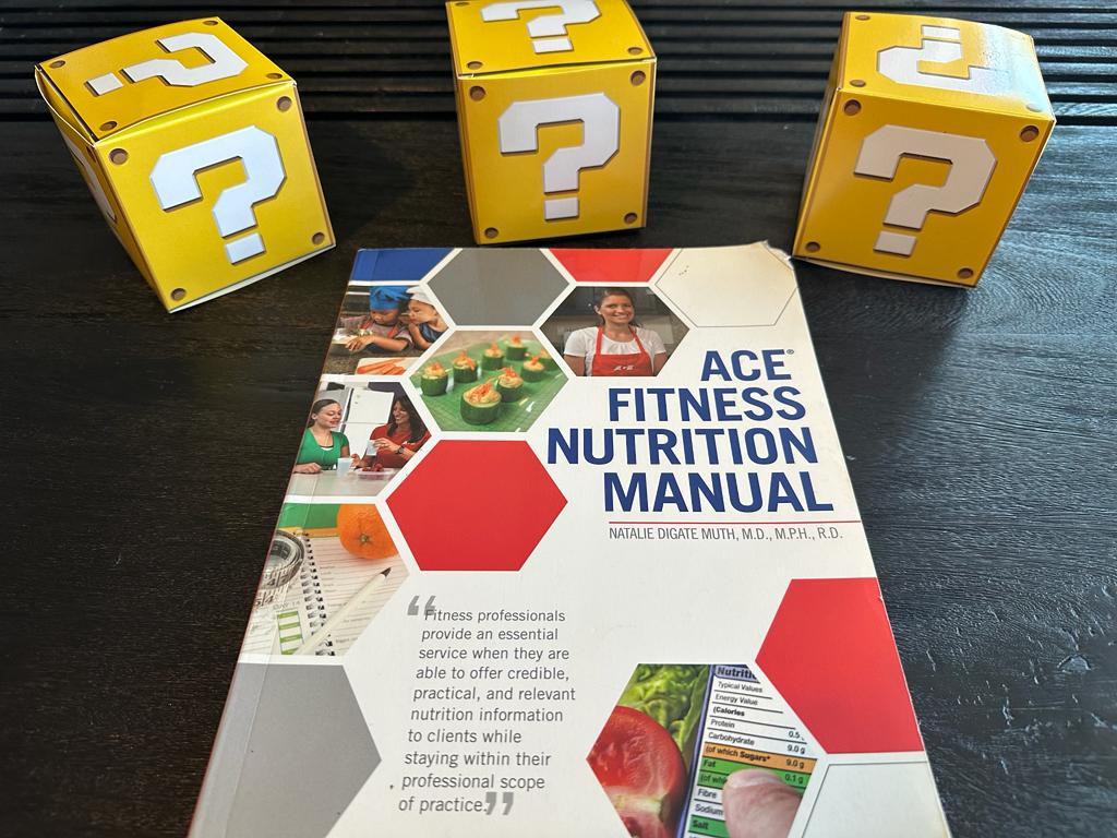 ACE nutrition textbook laid out surrounded by yellow question mark boxes - best nutrition certification