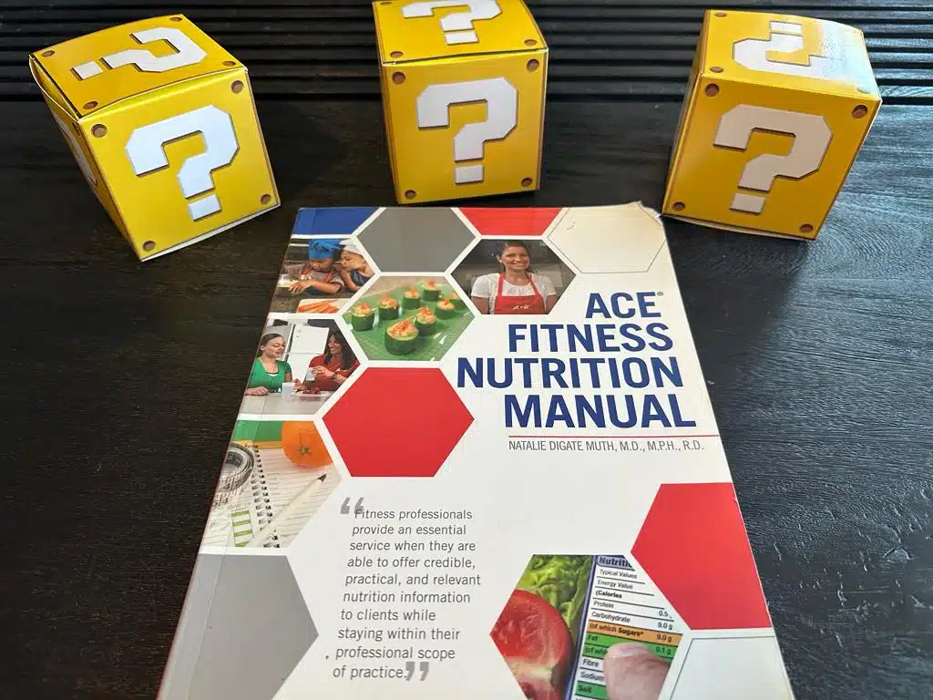 ACE nutrition textbook laid out surrounded by yellow question mark boxes - best nutrition certification