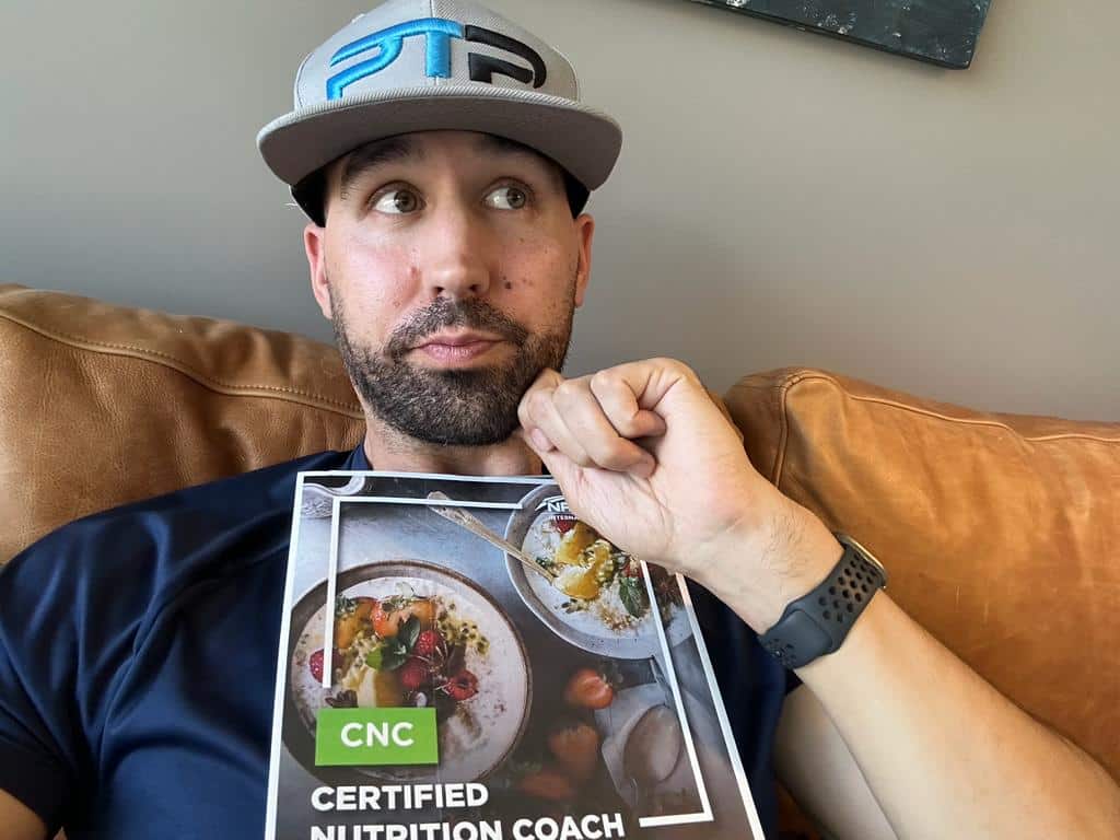 Is the NASM CNC worth it? NASM CNC Review - Tyler Read holds the NASM nutrition textbook and decides if it's worth it for his nutrition coach career.