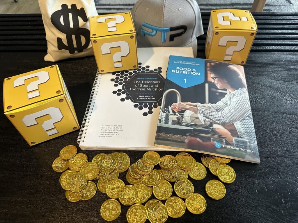 Precision Nutrition cost and packages - Precision Nutrition certification textbook on table with coins