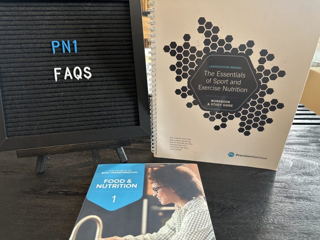 Precision Nutrition FAQs - PN certification frequently asked questions - Precision Nutrition level 1 certification textbooks set on table