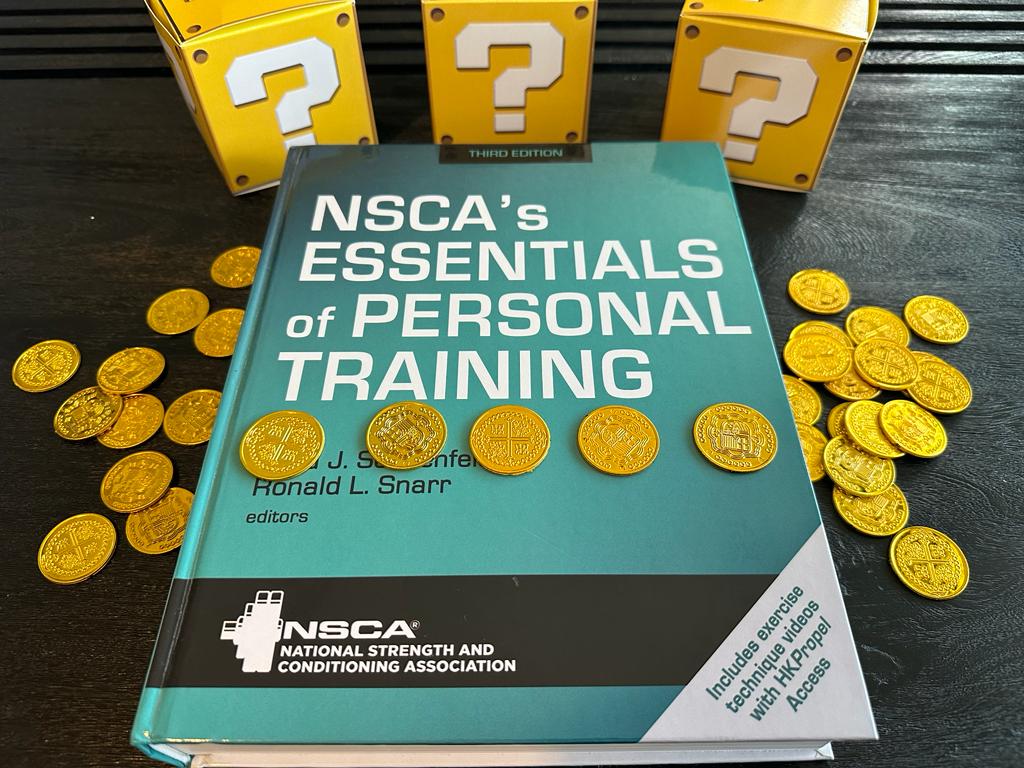 Cheapest personal training certifications - NSCA textbook laid out on table with gold coins and mystery boxes - how much does NSCA CPT cost?