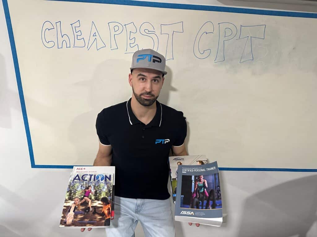 Tyler Read holds up the cheapest personal trainer textbooks against a while board with "cheapest CPT" on it