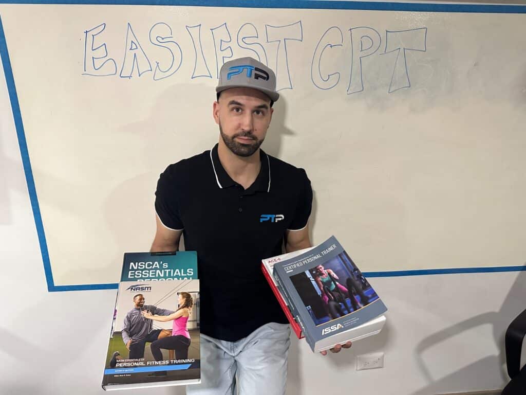 Easiest personal training certifications review. Tyler Read holds the textbooks in front of white board saying easiest cpt