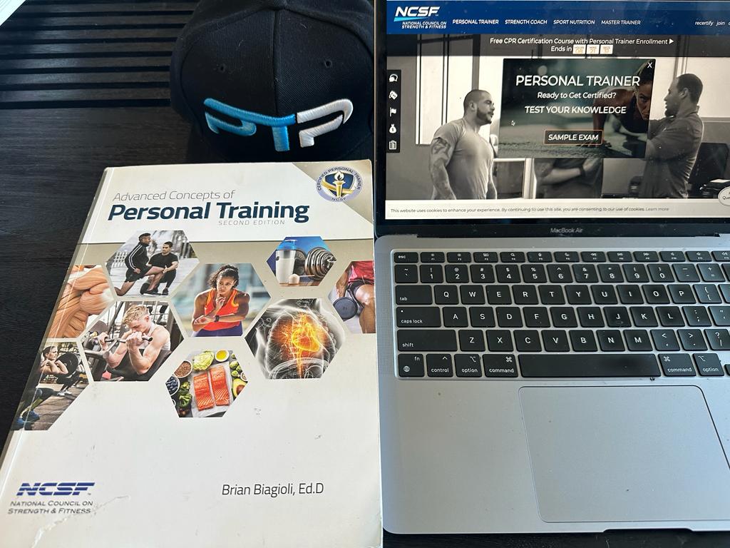 best online cpts - ncsf personal training textbook next to laptop showing ncsf website and ptpioneer hat