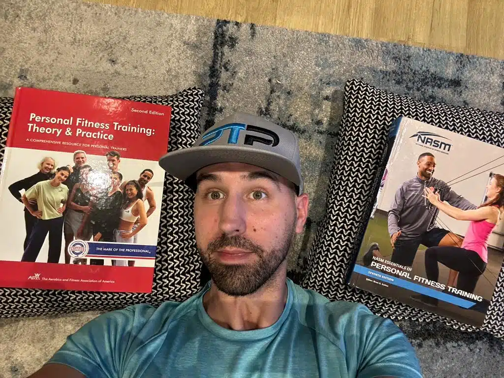 NASM vs AFAA Certification Comparison Review 15 nasm vs afaa - Tyler Read lies on floor with afaa and nasm textbooks