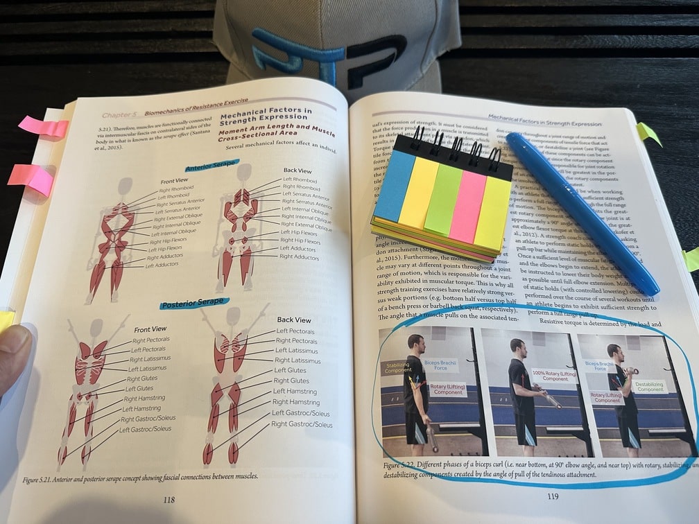 CSCCA Review - Become a Strength & Conditioning Coach 21 CSCCa certification - textbook open to biomechanics chapter with highlighted section and post it notes - how are the study materials for CSCCa