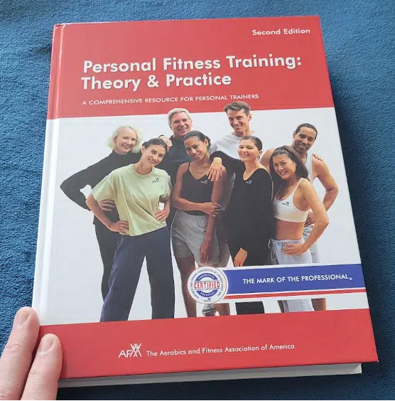 Tyler showing the physical AFAA PFT textbook cover