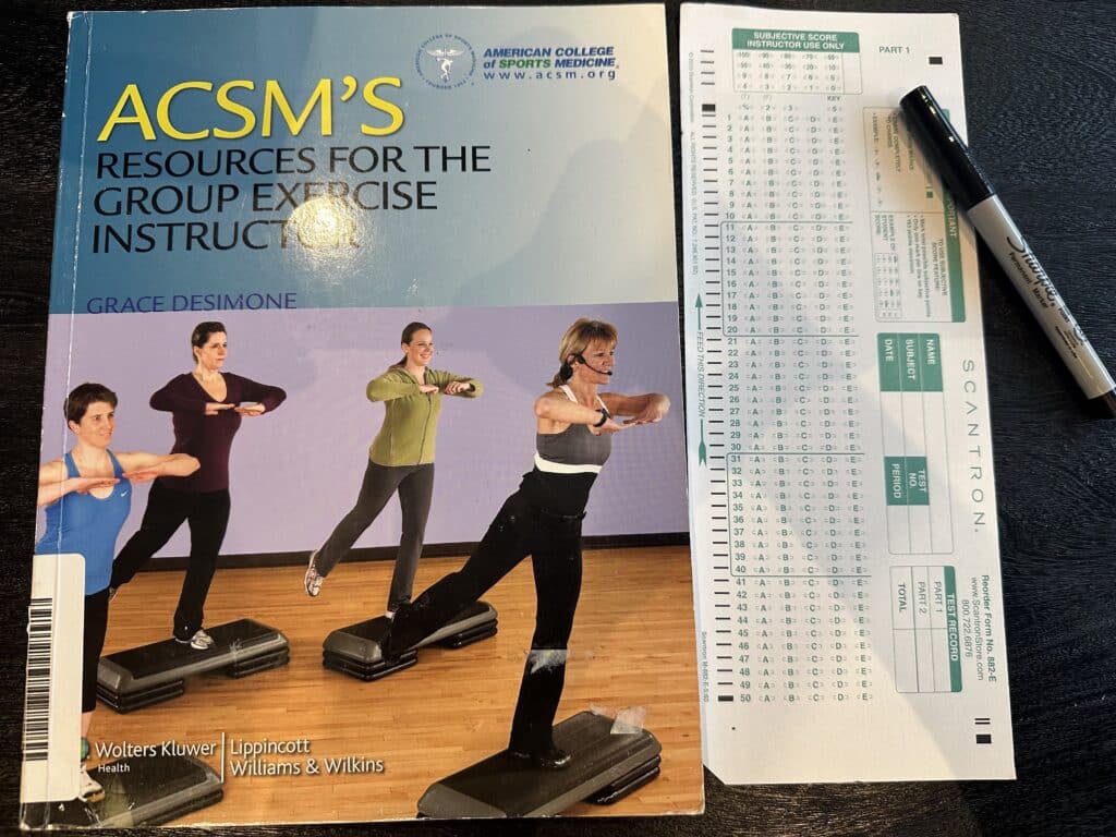 ace group exercise certification exam - ACSM GEI exam and textbook on table