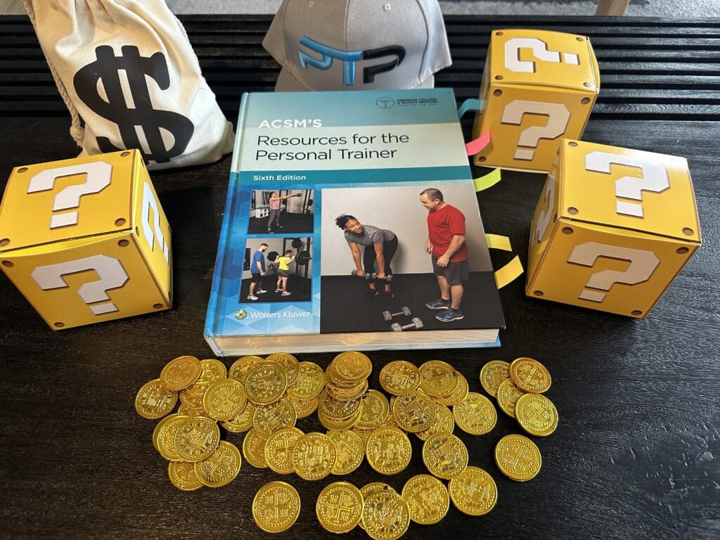 ACSM Certification Cost and Packages - gold coins and acsm textbook laid out on table