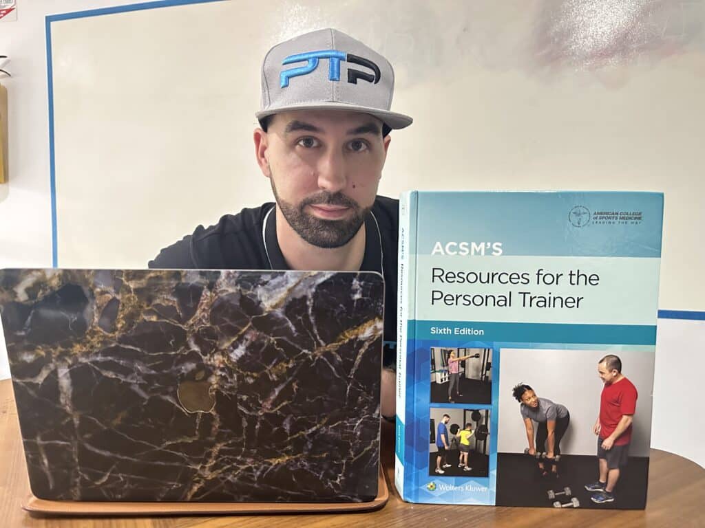 acsm cpt review - Tyler Read holding the ACSM certification textbook