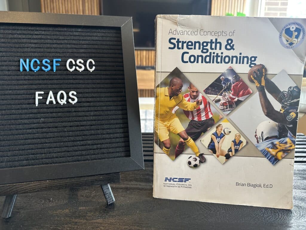 ncsf strength and conditioning faqs - NCSF textbook on table with FAQ board