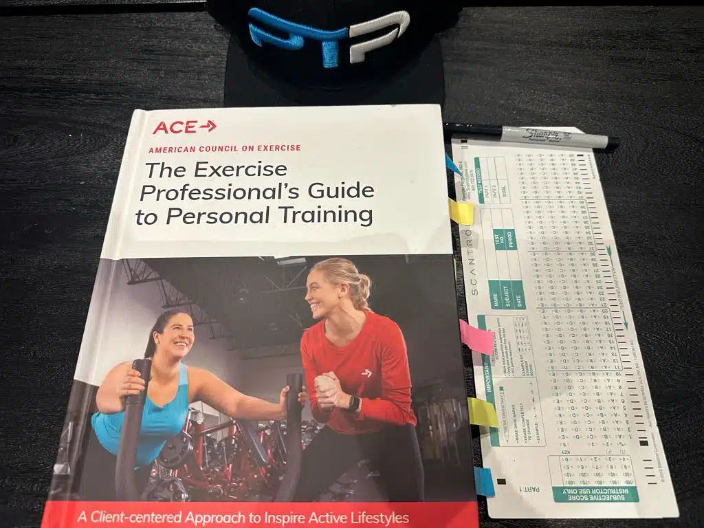 ACE practice test - ACE textbook laid out on table with scantron sheet for the ACE exam.