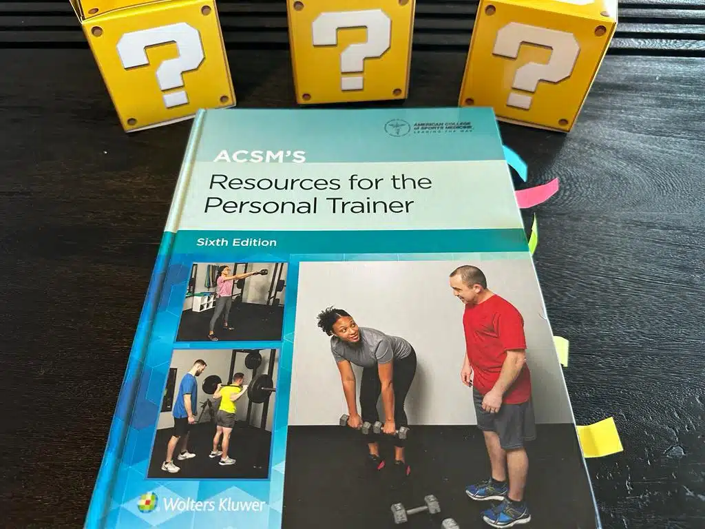 ACSM CPT - Best Personal Trainer Certification programs - ACSM textbook laid out with yellow question boxes 