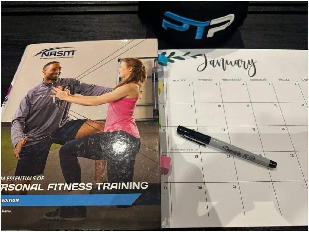 Free NASM Study Plan, Study Calendar, and Blueprint - NASM textbook next to a calendar preparing the study blueprint