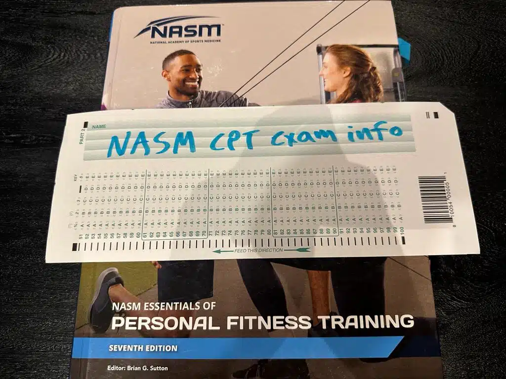 NASM CPT exam info - NASM textbook displayed on table with NASM exam info
