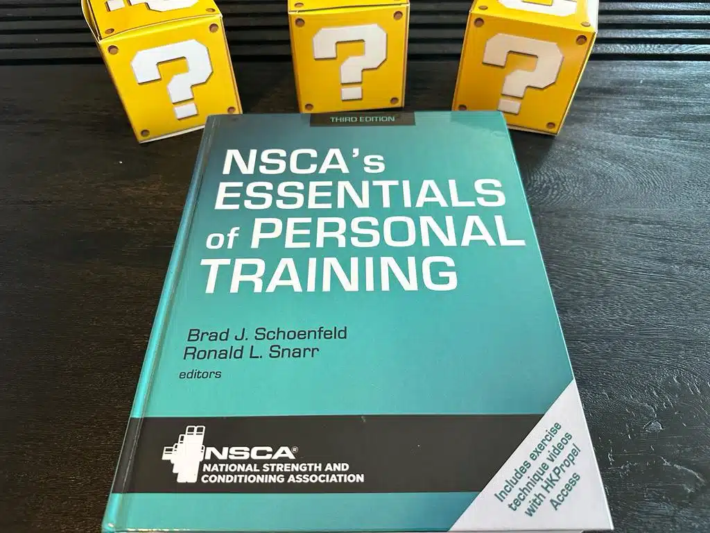 NSCA CPT - Best Personal Trainer Certification programs - NSCA textbook laid out with yellow question mark boxes 