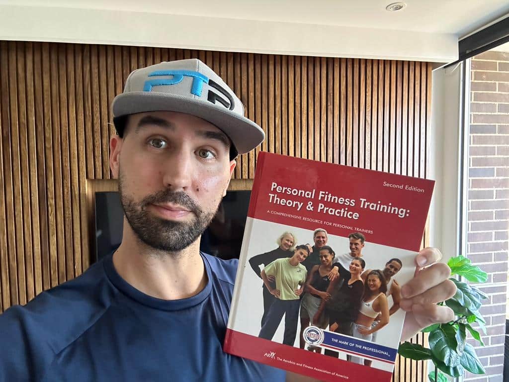 afaa cpt review - Tyler Read holds up the AFAA textbook to review the AFAA personal trainer certification