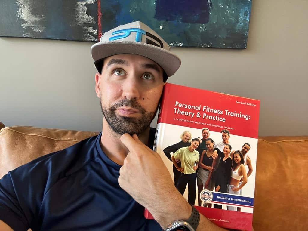 is afaa worth it? Tyler Read holding the AFAA textbook and deciding if AFAA personal training certification is worth it