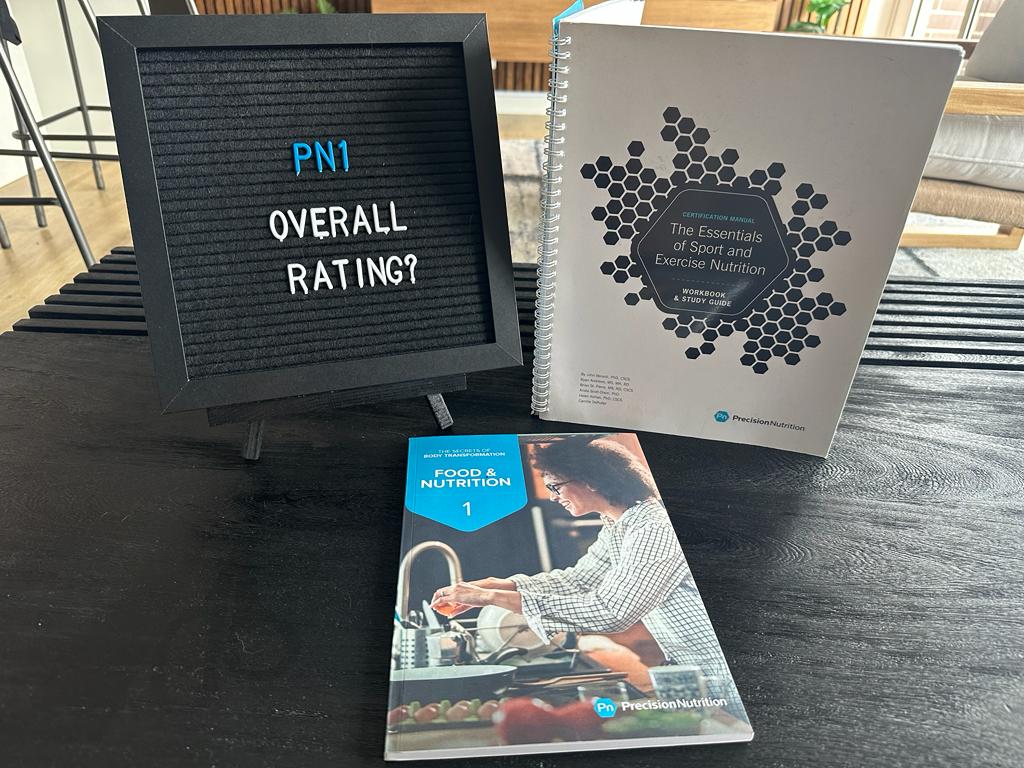 Precision Nutrition certification overall rating with textbook and letters displayed on table