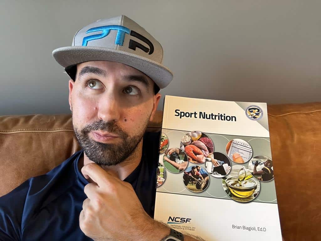 is the NCSF SNS worth it? Tyler Read holding the Sports Nutrition Certification textbook and deciding if the NCSF is worth it