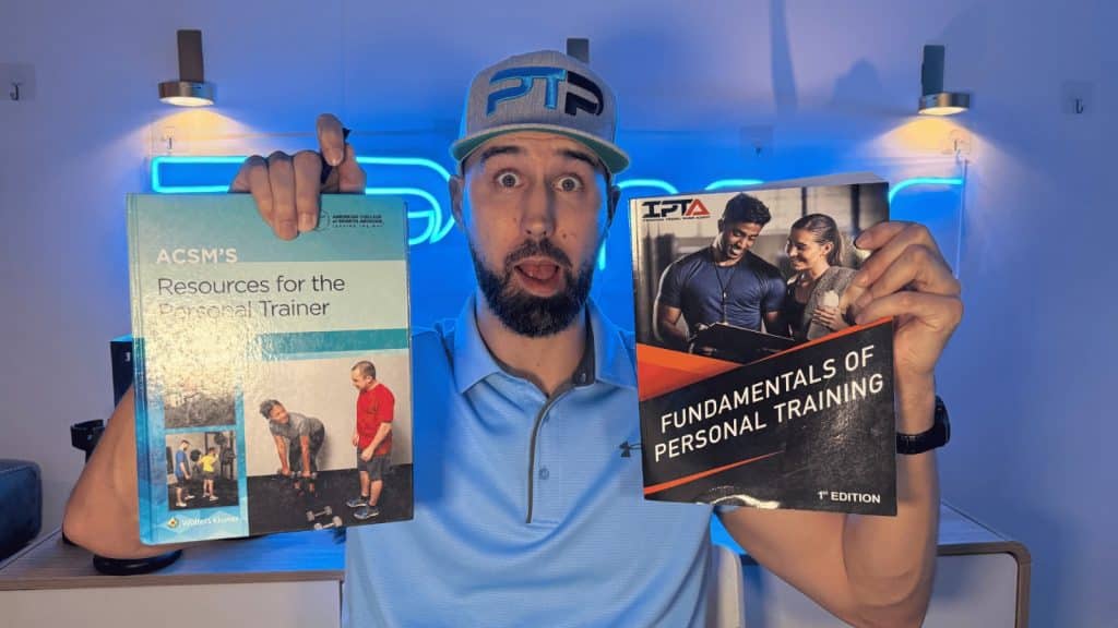 Tyler holding IPTA and ACSM textbooks