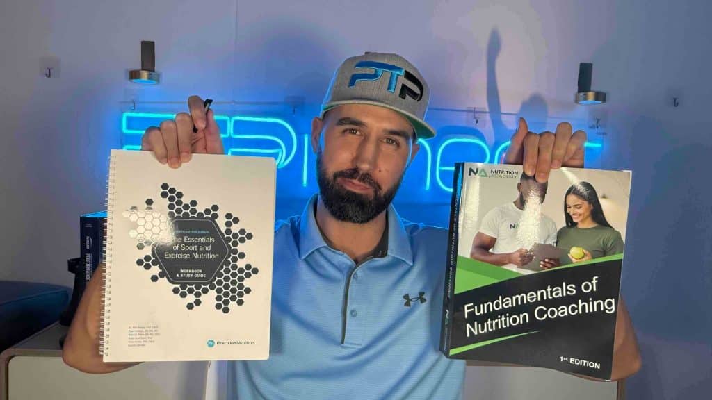 Tyler Read holds up Precision Nutrition and IPTA CNS textbooks, which is best?