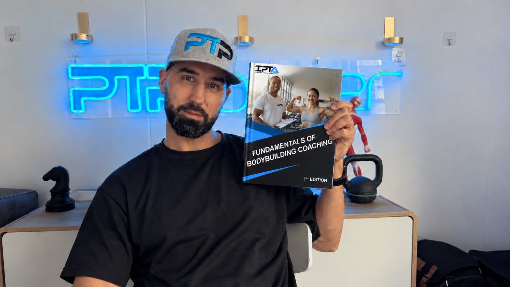 IPTA CBS Review: Is the Certified Bodybuilding Specialist Worth It? 3 Tyler holding the IPTA CBS textbook