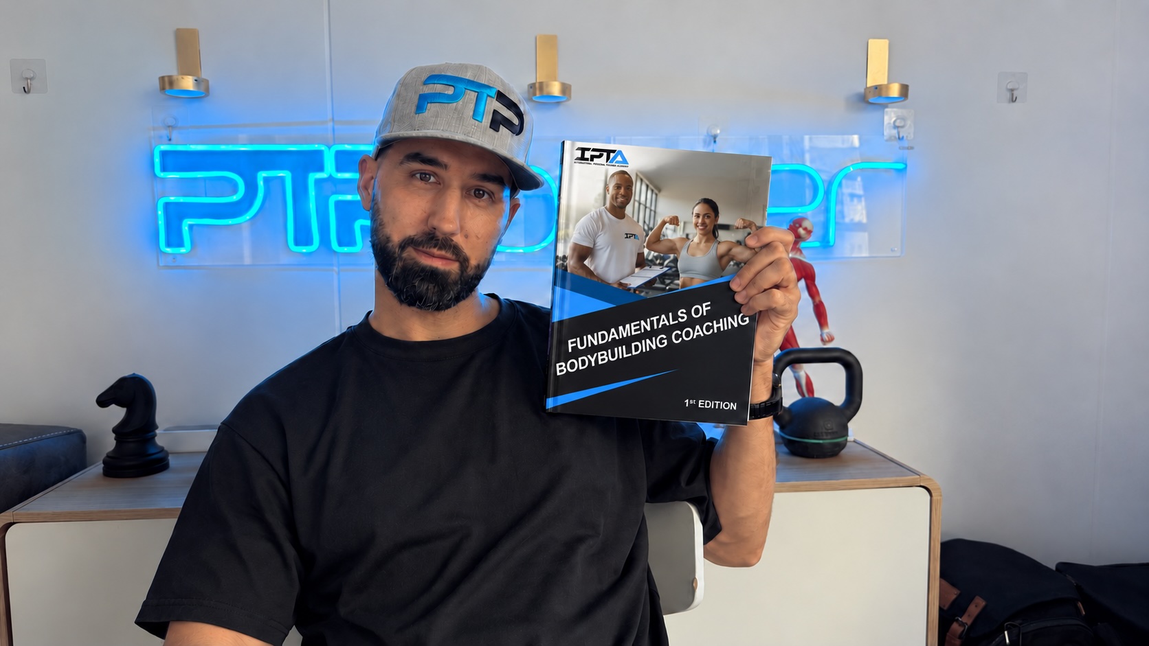 Tyler holding the IPTA CBS textbook
